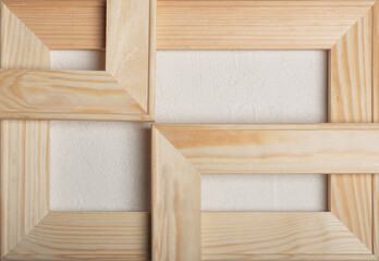 Three stretcher frames are lying on a white table.