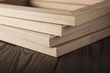 Fototapeta premium Four wooden stretcher frames on textured table.