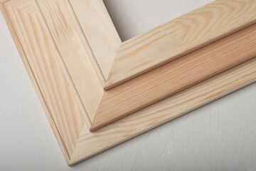 Three stretcher frames are lying on a white table.