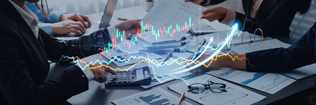 Business professionals in a modern office environment collaborate on analyzing financial data and market trends, using various tools and documents to drive insights. Scalp - Powered by Adobe