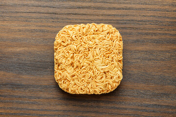 Top view of dried instant noodles on wooden table