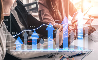 A group of professionals collaborates in a modern office, analyzing graphs and charts that showcase...