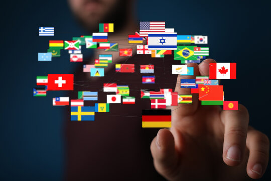 Person's hand connecting to a network of international flags, symbolizing global unity, communication, and travel. Perfect for representing dive