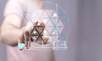Person interacts with digital health interface showing medical icons and data. Modern healthcare technology.