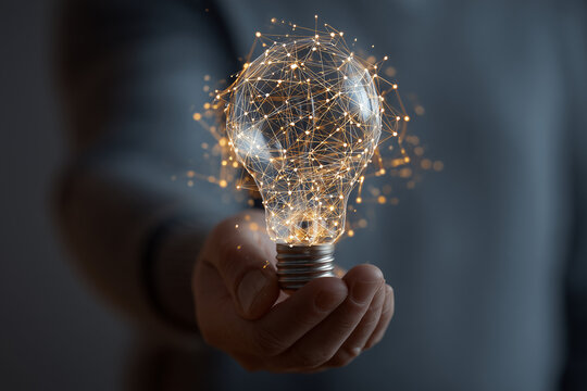 Hand businessman holding light bulb with mesh light line.future technology,Alternative energy,idea,saving electricity innovation and inspiration concepts