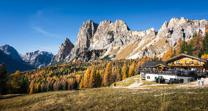 Autumn in the Dolomites. Explosion of colors towards sunset. Enrosadira and larch forests