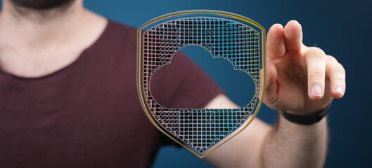 Concept of cloud security, data protection, and information security with a person touching a shield with a cloud symbol. Symbolizes
