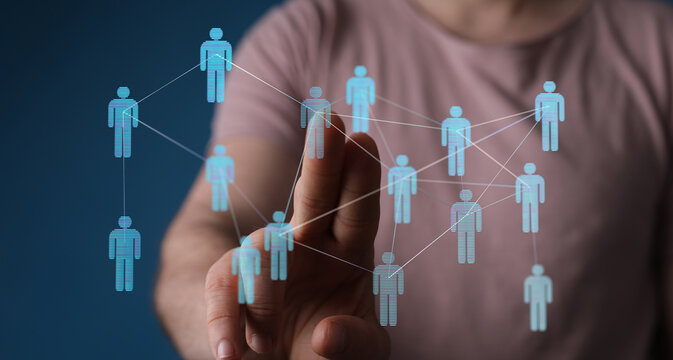 Hand touching network of human icons, representing connection, communication, social media, teamwork, and globa