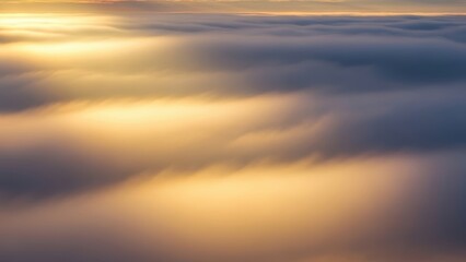 Aerial view of dense cloud cover illuminated by golden sunset or sunrise light