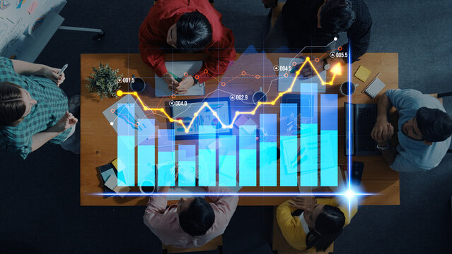 A diverse team collaborates in a modern office, analyzing financial data with colorful graphs and charts to enhance strategies and drive growth. Scalp - Powered by Adobe