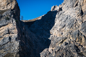 Autumn in the Dolomites. Explosion of colors towards sunset. Enrosadira and larch forests