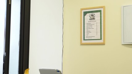 Slow motion capture of a celebratory high five between tattooed hairdresser and smiling young client as he leaves