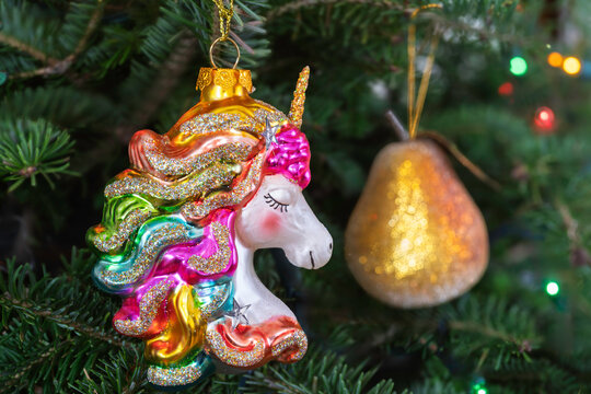 Unicorn glass hanging ornament hanging in a Christmas tree.