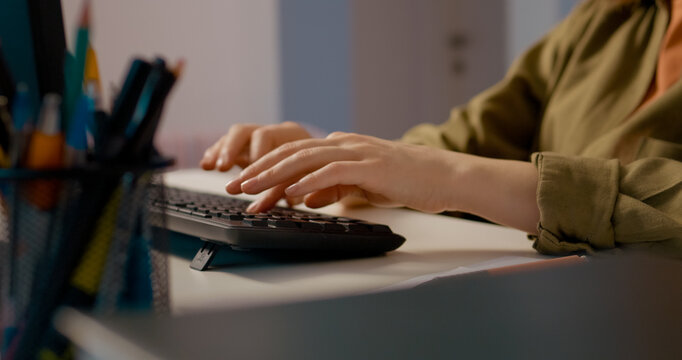 Close up of a woman hands typing on a keyboard at her home office, focused on her work as a freelancer, showcasing her remote job routine and productivity. - Powered by Adobe
