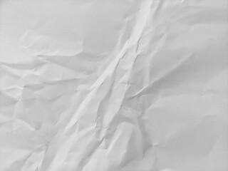 Obraz premium White crumpled paper texture background featuring a wavy surface. Crumpled white paper pattern texture.