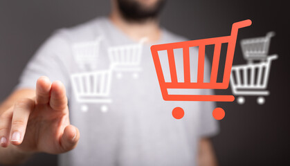Person interacting with virtual shopping cart icons. Concept of online retail, e-commerce, digital marketing and purchasing experience. Modern t
