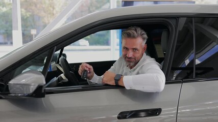 Man customer male buyer client wears white show keys fob keyless system shirt chooses auto wants to buy new automobile in car showroom vehicle salon dealership store motor show indoor. Sales concept