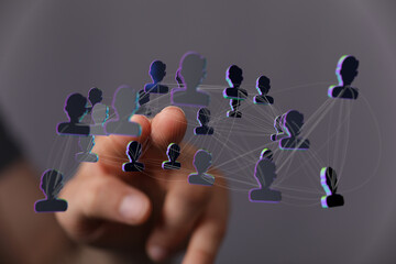 Visual representation of network, with hand touching the silhouette digital network, symbolizing human connection and online collaboration.