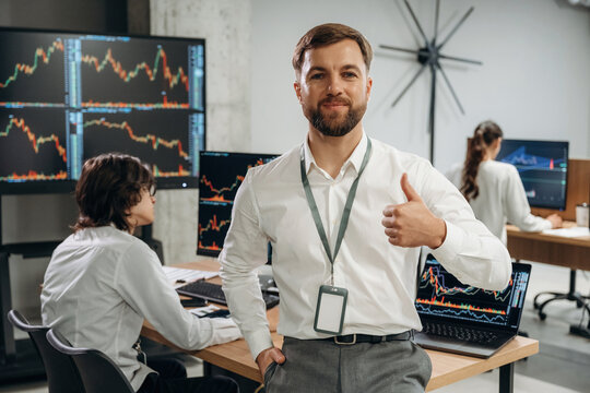 Boss is standing in front of workers. Business people are working with stock market exchange in office - Powered by Adobe