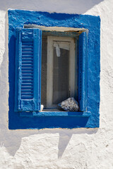 Blue window on white old wall