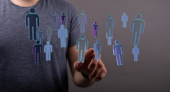 Concept of networking, teamwork and communication represented by hand touching digital human figures. Teamwork and unity in the digital era.