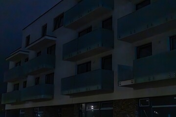 A multi-story building with dark windows at night. Power outages due to the war in Ukraine.