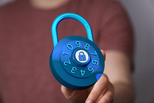 Secure digital lock with a numeric dial in hand, representing data protection and online security. Concept for