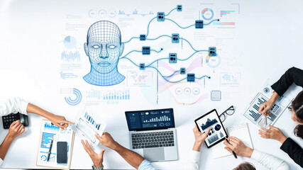A diverse professional team collaborates in an office space, analyzing data using laptops and tablets, with visual digital representations of AI concepts enhancing their discussion. Trope