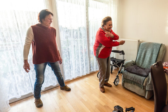 Senior woman exercising with family support for mobility, fitness, contracture prevention and fall prevention - Powered by Adobe
