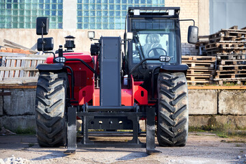 Black and red telehandler versatile agricultural and construction vehicle with attachment heavy...
