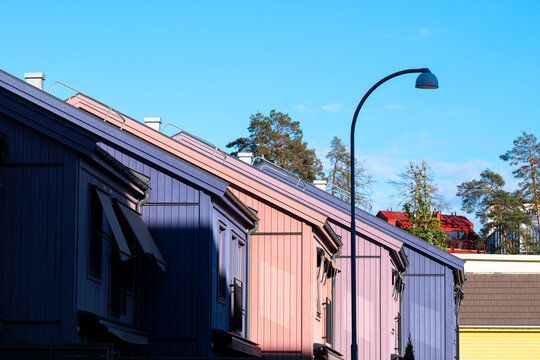 Urban architecture and Scandinavia housing in a Stockholm residential area with modern facades expressing minimalism and enhanced by the clarity of clean light throughout the scene