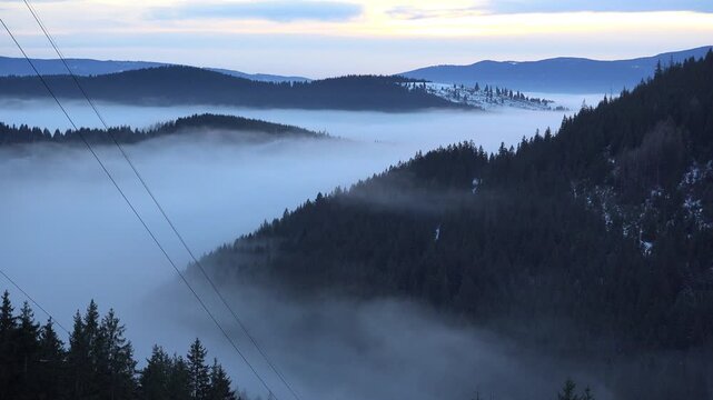Mist down on mountains valley early in the morning