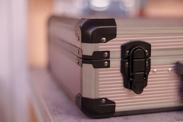 Stylish aluminum suitcase resting on a sleek surface with a modern design