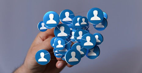 Hand displaying a digital network of connected people, representing social networking and global communication.