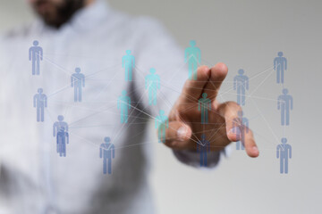 Hand touching digital human figures, concept of networking, communication, teamwork and social media. Ideal for