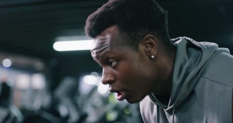 Tired, black man and drinking water with sweat in fitness gym for hydration, rest or recovery. Exhausted, male person or breathing with mineral liquid or beverage for workout break in health club - Powered by Adobe