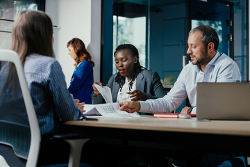 Diverse Business Team Collaborating in Modern Glass Office