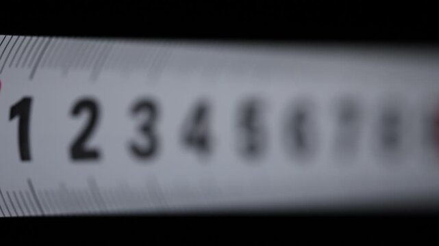 White metal ruler, professional tool, macro details, Macro photography of a white ruler with slow focus transition on a black background