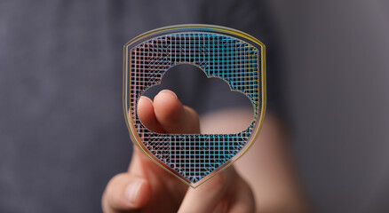 Secure cloud data storage with protection concept, hand touching digital shield. Concept of safe network and digital security.