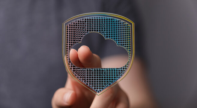 Secure cloud data storage with protection concept, hand touching digital shield. Concept of safe network and digital security.