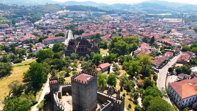 Cinematic Aerial View of Guimaraes, Portugal &mdash; Historic Medieval City, Castle, Stone Streets and Scenic Urban Landscape from Drone