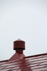 Air vent on top of red roof of agricultural farm building, Hokkaido, Japan