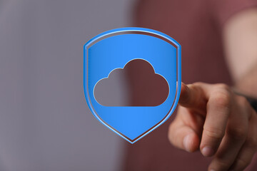 Person interacting with cloud data protection icon, conveying digital security and cloud-based services. Modern