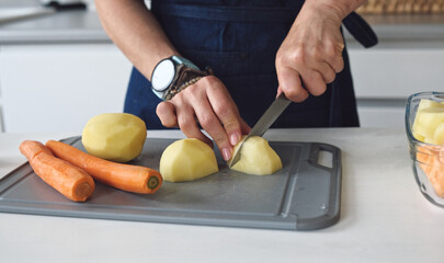 Woman Is Cutting Raw Potatoes