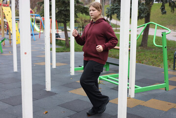 Fit girl training on the outdoor playground. Active lifestyle