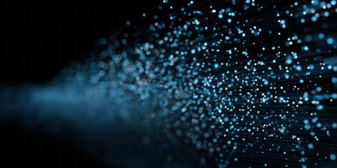 Illumination streams outward from a dense concentration of bright, glowing particles against a dark background.