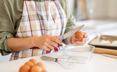 Woman Is Cracking Egg For Baking