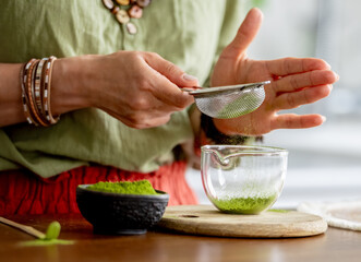 Woman Sifting Matcha Tea