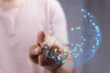 Person's hand touching a digital sphere representing interconnectedness, technology, and global communication. Concept of innovation, network.