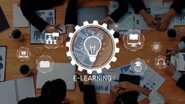 A top-down view of a workspace featuring hands engaged in discussion around e-learning tools and resources, emphasizing creativity and collaboration in education. Raster